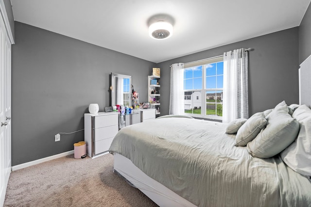 bedroom featuring baseboards and carpet flooring