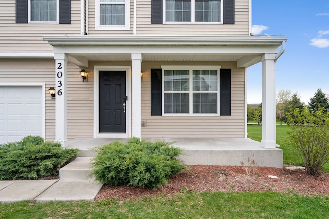 view of exterior entry featuring covered porch