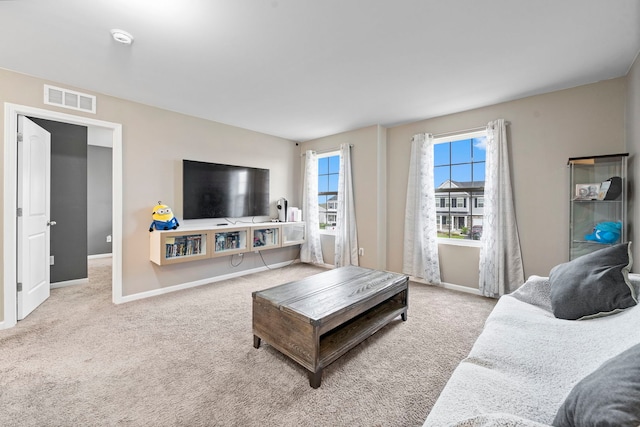 carpeted living room featuring visible vents and baseboards