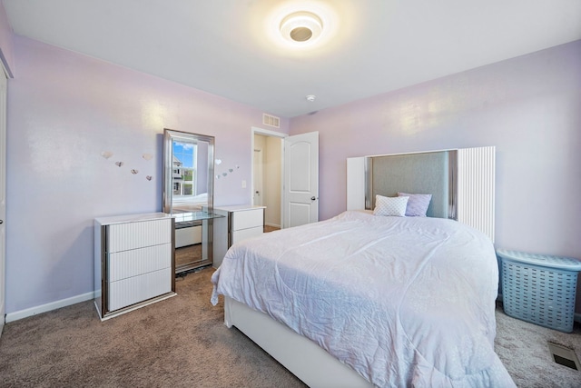 bedroom with baseboards, visible vents, and light carpet