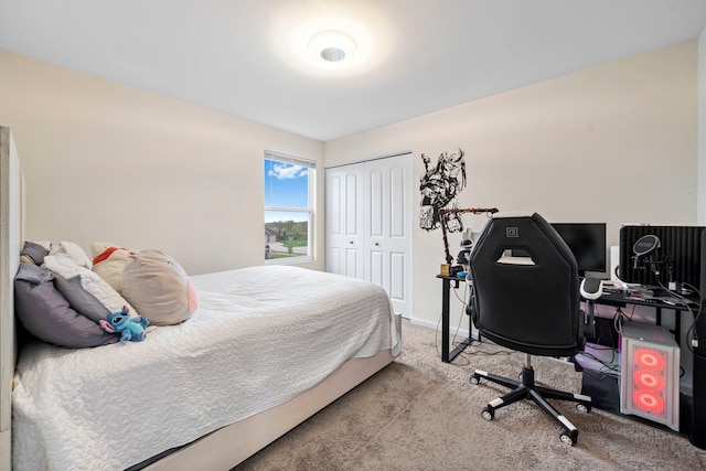carpeted bedroom with a closet and baseboards