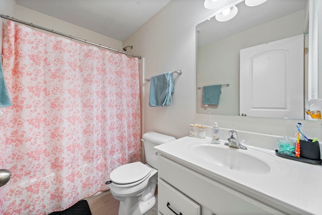full bath featuring vanity, wood finished floors, toilet, and a shower with curtain