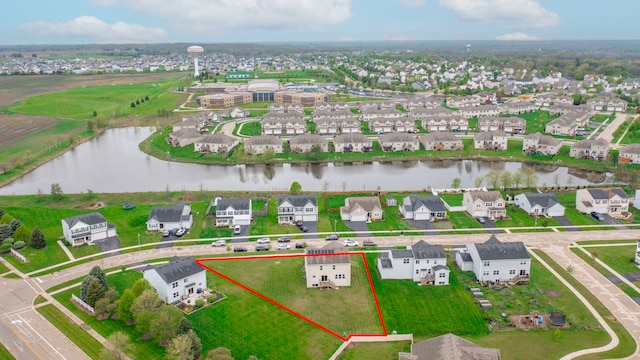 drone / aerial view featuring a residential view and a water view
