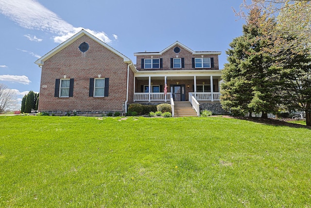 view of front facade with brick siding, a front yard, a porch, and stairs