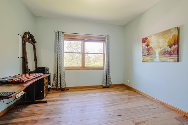 bedroom featuring light wood-style flooring and baseboards