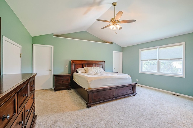 bedroom featuring vaulted ceiling, light carpet, ceiling fan, and baseboards