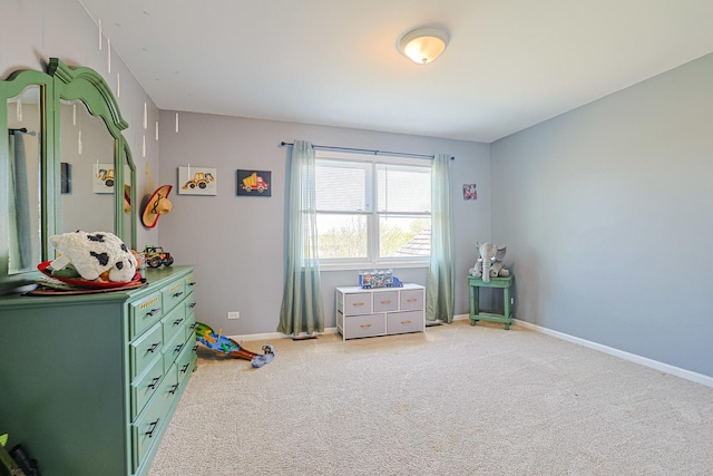 bedroom featuring light colored carpet and baseboards