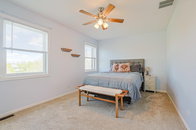 bedroom featuring light carpet, baseboards, and ceiling fan