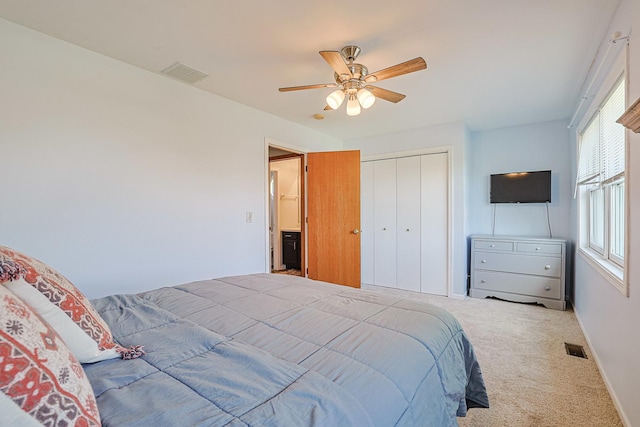 carpeted bedroom with a closet, ceiling fan, and baseboards
