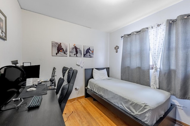 bedroom with wood finished floors