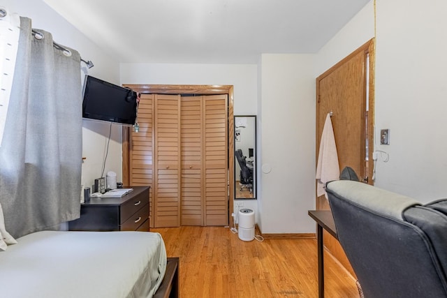 bedroom featuring light wood-type flooring and a closet