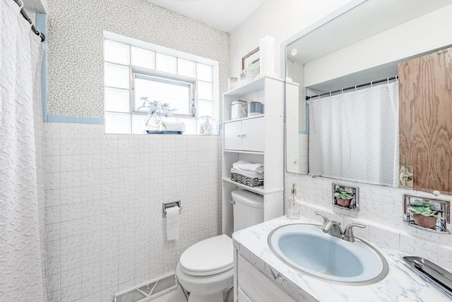 bathroom with vanity, visible vents, and toilet