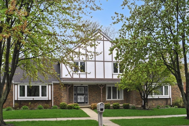 23 Westmoreland Ln, Naperville, IL 60540 - tudor home featuring stucco siding, a front lawn, and brick siding