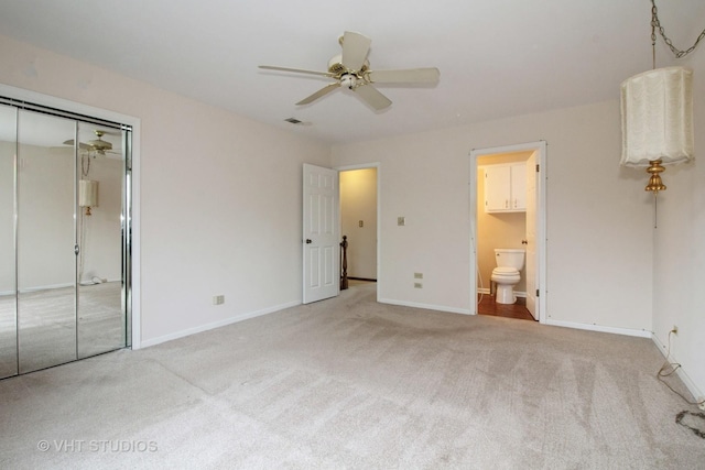 23 Westmoreland Ln, Naperville, IL 60540 - unfurnished bedroom with a closet, baseboards, ceiling fan, connected bathroom, and carpet flooring