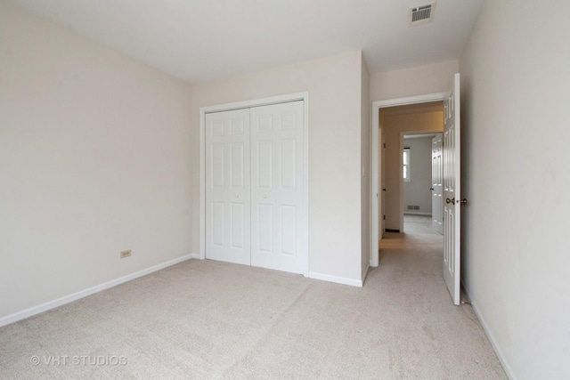 23 Westmoreland Ln, Naperville, IL 60540 - unfurnished bedroom with baseboards, visible vents, light carpet, and a closet