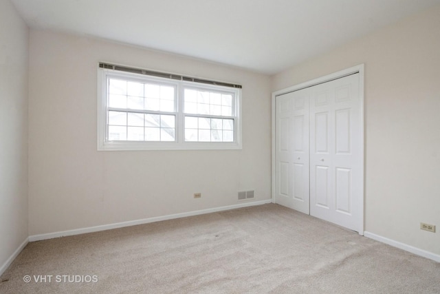 23 Westmoreland Ln, Naperville, IL 60540 - unfurnished bedroom with visible vents, carpet, baseboards, and a closet