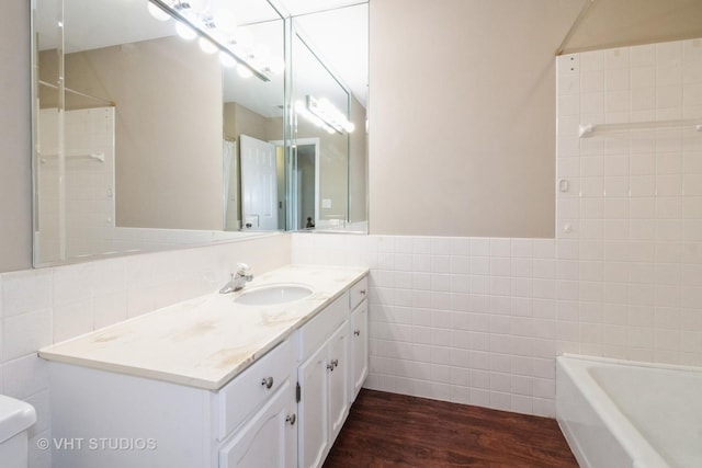 23 Westmoreland Ln, Naperville, IL 60540 - bathroom with vanity, a bathing tub, toilet, tile walls, and wood finished floors