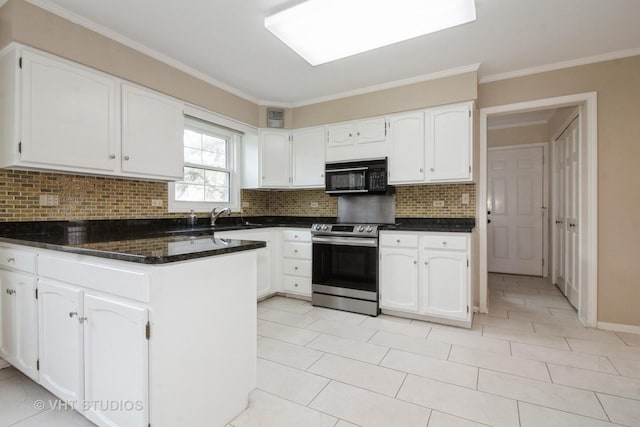 23 Westmoreland Ln, Naperville, IL 60540 - kitchen with electric range, black microwave, white cabinetry, a peninsula, and tasteful backsplash