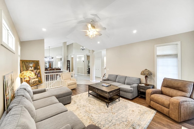 13083 Timber Ct, Palos Heights, IL 60463 - living area featuring ceiling fan with notable chandelier, wood finished floors, and vaulted ceiling