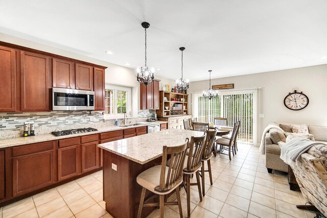 13083 Timber Ct, Palos Heights, IL 60463 - kitchen with tasteful backsplash, open floor plan, an inviting chandelier, stainless steel appliances, and light tile patterned flooring