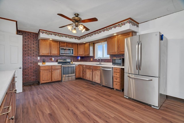 23678 N 2700 E Rd, Odell, IL 60460 - kitchen featuring appliances with stainless steel finishes, a sink, dark wood-style flooring, a ceiling fan, and light countertops
