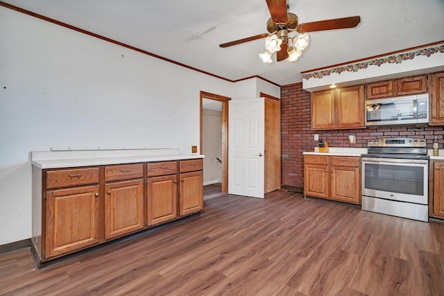 23678 N 2700 E Rd, Odell, IL 60460 - kitchen featuring appliances with stainless steel finishes, dark wood-style floors, light countertops, ceiling fan, and crown molding