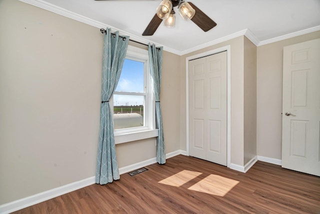 23678 N 2700 E Rd, Odell, IL 60460 - unfurnished bedroom featuring baseboards, wood finished floors, crown molding, a ceiling fan, and a closet