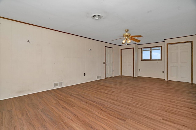 23678 N 2700 E Rd, Odell, IL 60460 - unfurnished bedroom with two closets, light wood-style flooring, crown molding, baseboards, and ceiling fan