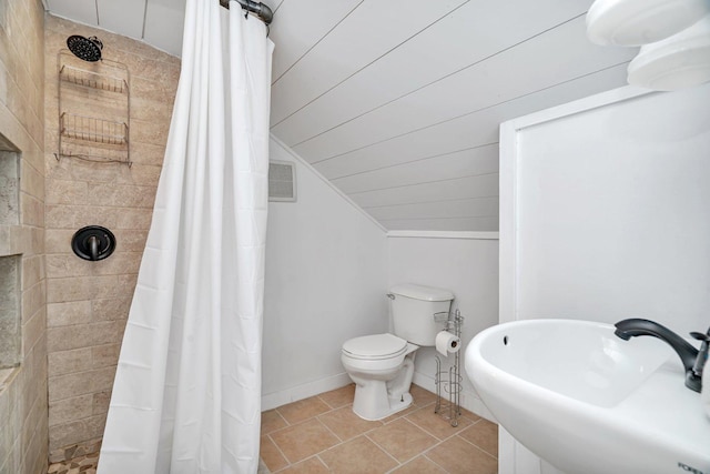 23678 N 2700 E Rd, Odell, IL 60460 - bathroom with lofted ceiling, toilet, tiled shower, a sink, and tile patterned flooring