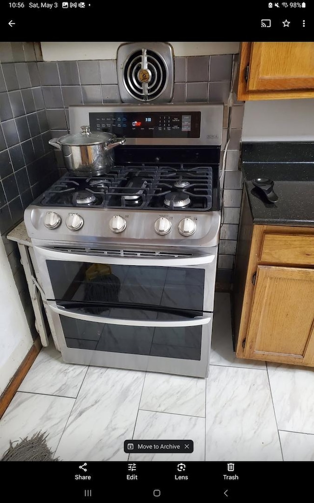 kitchen view of double oven range and backsplash