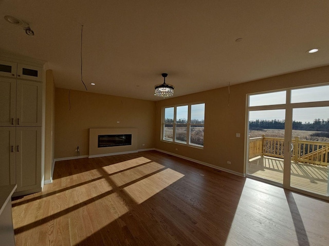 1221 Honey Lake Rd, Lake Zurich, IL 60047 - unfurnished living room with a glass covered fireplace, baseboards, recessed lighting, and wood finished floors
