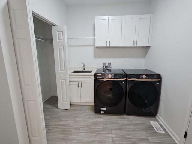 1221 Honey Lake Rd, Lake Zurich, IL 60047 - clothes washing area with cabinet space, a sink, baseboards, visible vents, and washer and clothes dryer