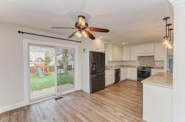 kitchen featuring ceiling fan, light wood finished floors, dishwasher, black refrigerator with ice dispenser, and stainless steel range with gas cooktop