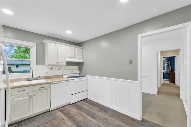 2603 Trafalgar Sq, Champaign, IL 61821 - kitchen featuring white appliances, a sink, dark wood finished floors, a wainscoted wall, and under cabinet range hood