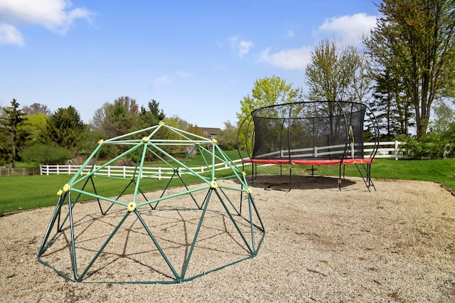 surrounding community featuring fence, a trampoline, and a yard