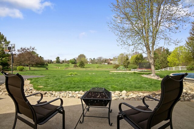 view of patio / terrace featuring fence and an outdoor fire pit