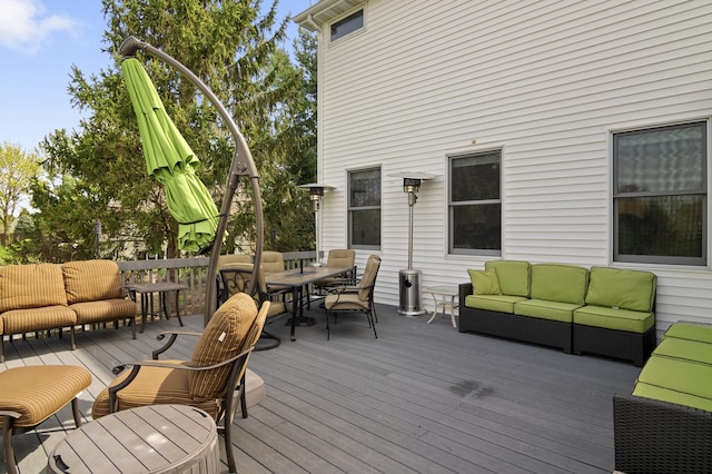wooden terrace with an outdoor hangout area and outdoor dining area