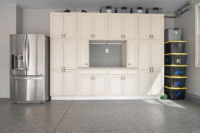 garage with stainless steel refrigerator with ice dispenser
