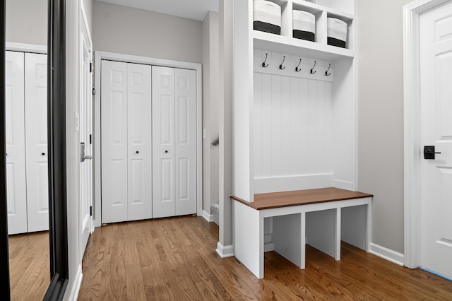 mudroom featuring baseboards and wood finished floors