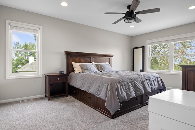 bedroom with light carpet, recessed lighting, baseboards, a ceiling fan, and visible vents