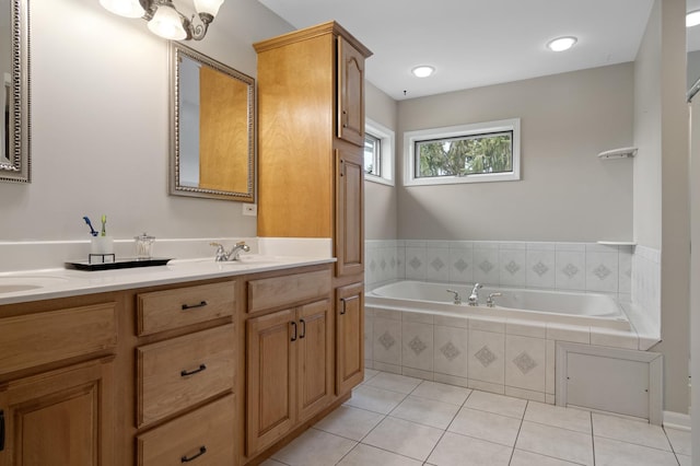 full bathroom with tile patterned flooring, a sink, a bath, and double vanity