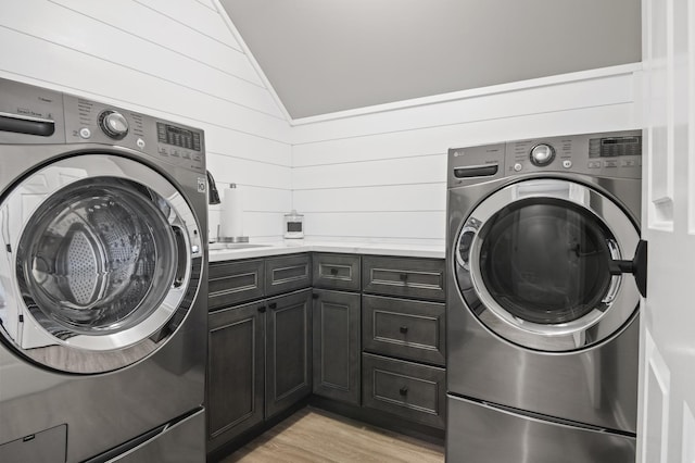 washroom featuring cabinet space, a sink, and light wood-style flooring