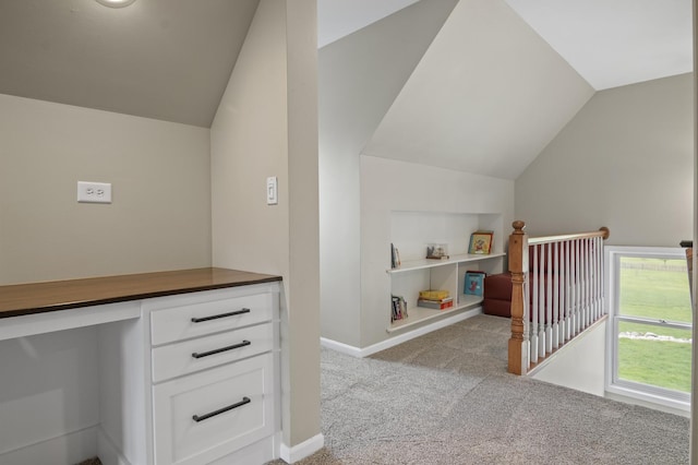 bonus room featuring built in study area, baseboards, vaulted ceiling, and carpet flooring
