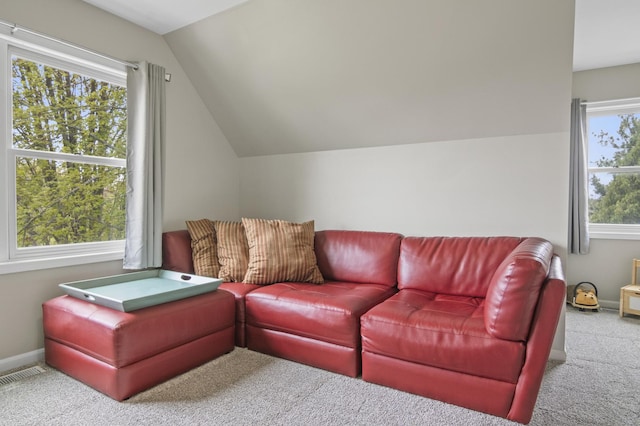 living room with carpet floors, baseboards, visible vents, and vaulted ceiling