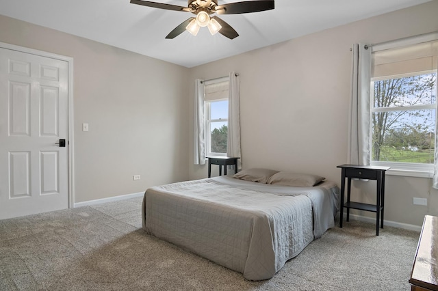 carpeted bedroom with baseboards and a ceiling fan