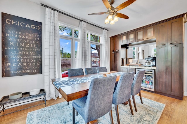 1800 W Melrose St, Chicago, IL 60657 - dining space with beverage cooler, light wood-type flooring, and a ceiling fan