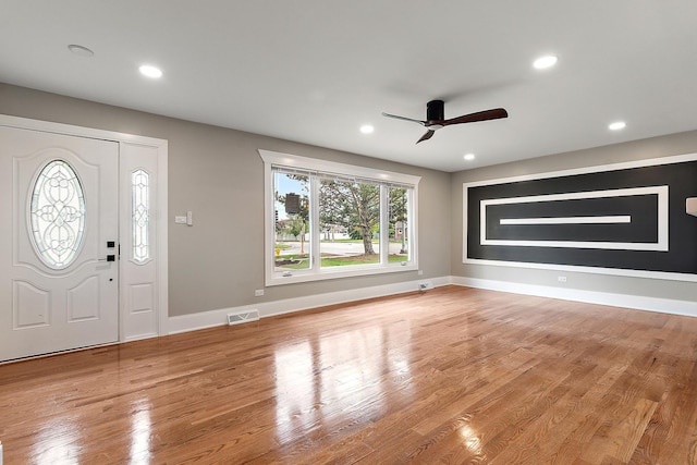 entrance foyer featuring visible vents, baseboards, ceiling fan, and wood finished floors