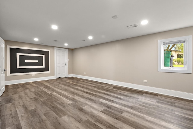 basement with dark wood-type flooring, recessed lighting, baseboards, and visible vents