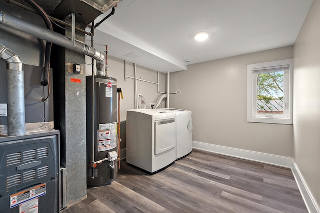 laundry area with washer and dryer, laundry area, water heater, baseboards, and wood finished floors