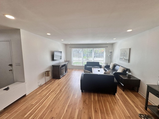 9911 Kedvale Ave, Skokie, IL 60076 - living area with recessed lighting, a wood stove, and light wood finished floors